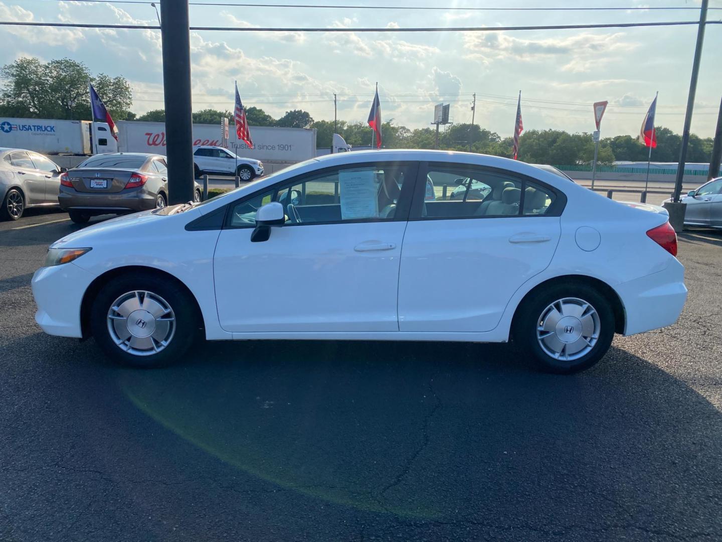 2012 WHITE Honda Civic HF Sedan 5-Speed AT (2HGFB2F61CH) with an 1.8L L4 SOHC 16V engine, 5-Speed Automatic transmission, located at 420 I-35E, Lancaster, TX, 75146, (469) 297-4144, 32.593929, -96.823685 - Photo#2