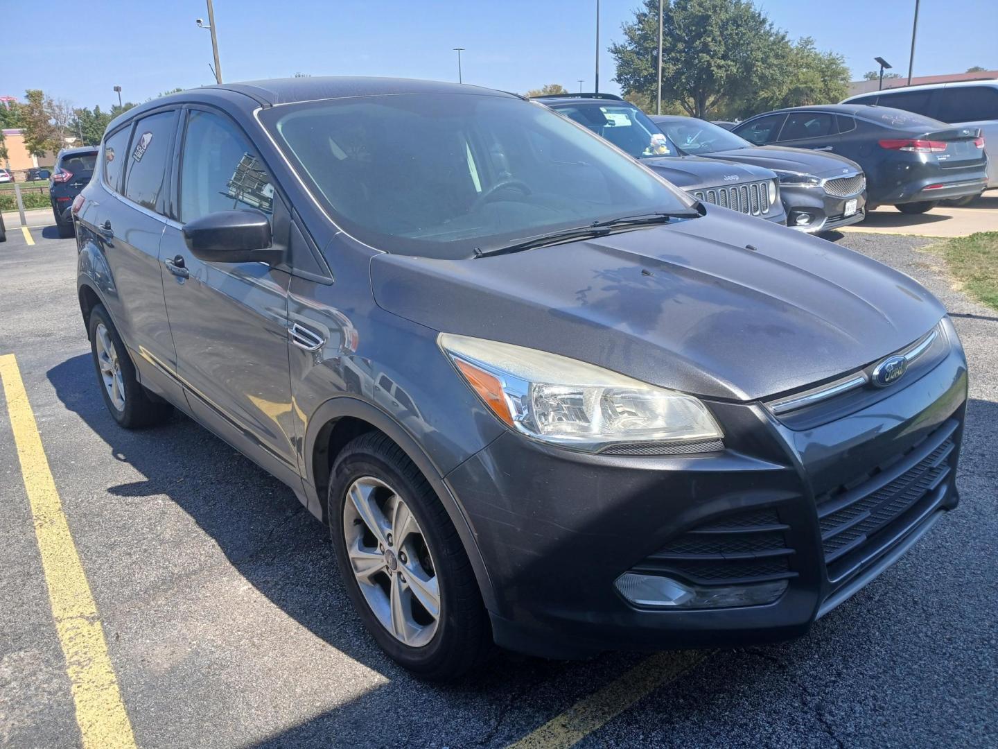 2015 GRAY Ford Escape SE 4WD (1FMCU9GX7FU) with an 1.6L L4 DOHC 16V engine, 6-Speed Automatic transmission, located at 420 I-35E, Lancaster, TX, 75146, (469) 297-4144, 32.593929, -96.823685 - Photo#2